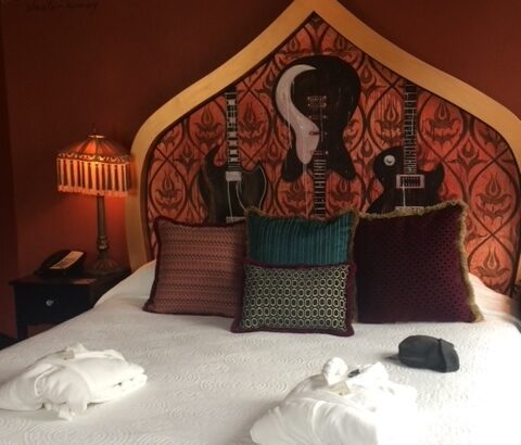 The bed in the corner suite Sleater-Kinney Room at the Crystal Hotel in Portland Oregon