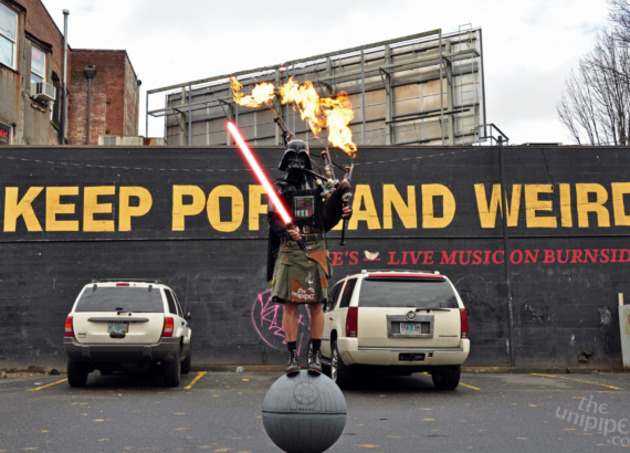 Keep Portland Weird sign, with the Unipiper in the foreground.