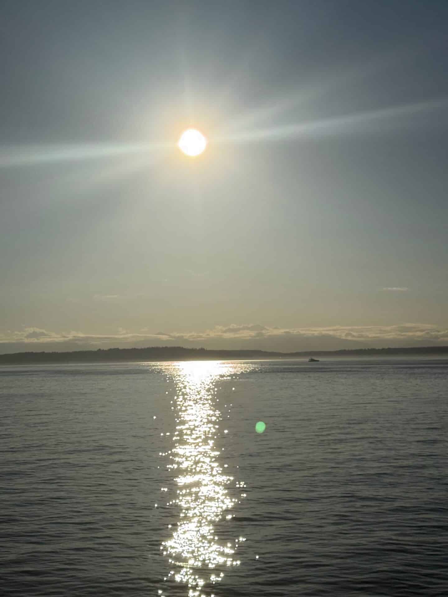 The sun hanging low in the sky on Elliott Bay in Seattle